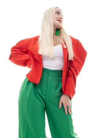 fashion shot. A beautiful blonde woman poses in bright clothes on a white background. Beauty, fashion concept.の写真素材