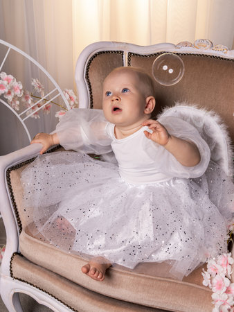 one year old baby, girl in angel wings photograph in studioの写真素材