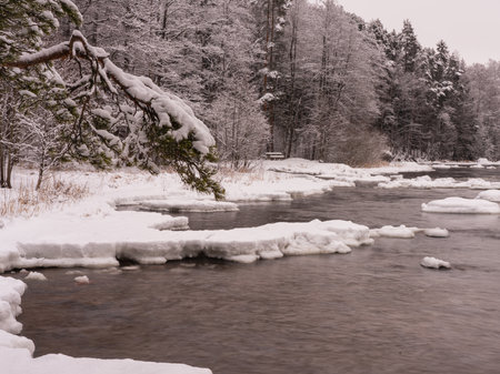Frozen river in winter with snow and ice. Beautiful winter landscape.の写真素材