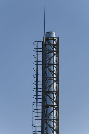 pipe manufacture blue sky background homogeneous industry pollution clogging metal chrome shiny metal a sunny dayの写真素材