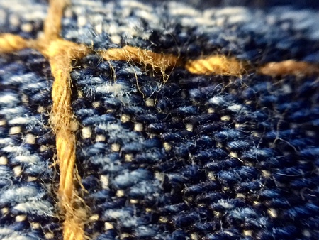 Close up of blue denim stitchingの素材