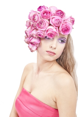 young beautiful woman with pink flowers on her head and in pink dressの写真素材