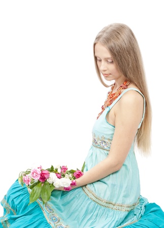 Beautiful woman with flowers in elegant blue sundress over white. Fashion photoの写真素材