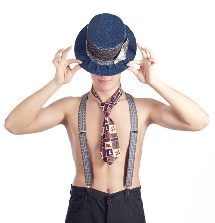 Young funny man posing in studio in clown hat over whiteの写真素材