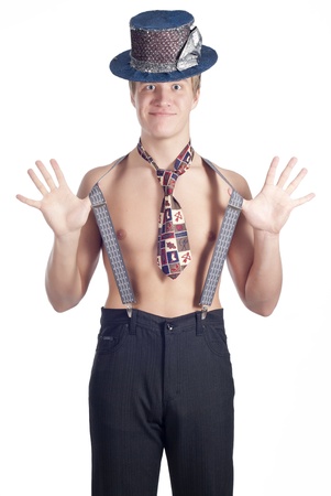 Young funny man posing in studio in clown hat over whiteの写真素材