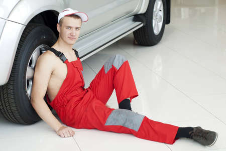 Handsome Auto mechanic near a car, young man portraitの写真素材