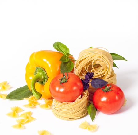 Tomato, macaroni, red and green basil, sweet pepper backgroundの写真素材