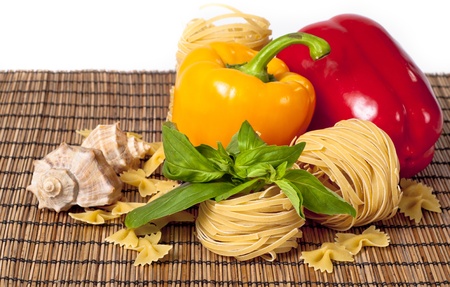 Tomato, macaroni, red and green basil, sweet pepper backgroundの写真素材