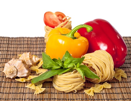 Tomato, macaroni, red and green basil, sweet pepper backgroundの写真素材