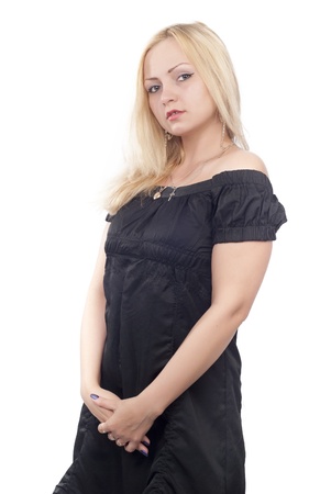 Beautiful blond young woman in black dress over whiteの写真素材