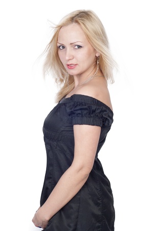 Beautiful blond young woman in black dress over whiteの写真素材