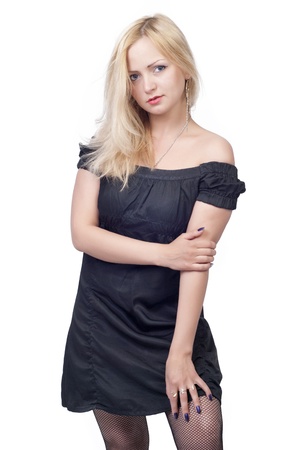 Beautiful blond young woman in black dress over whiteの写真素材
