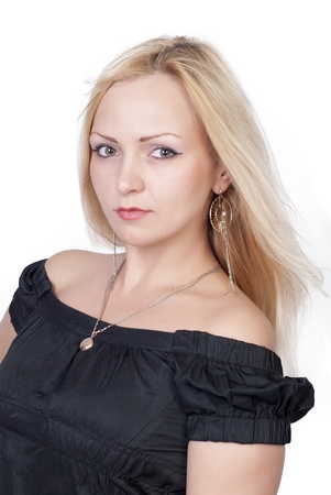 Beautiful blond young woman in black dress over whiteの写真素材