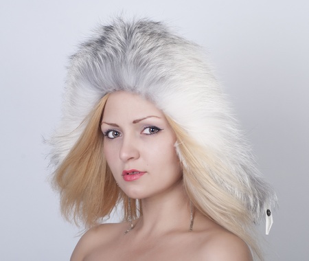 Beautiful young woman in fur hat, portraitの写真素材