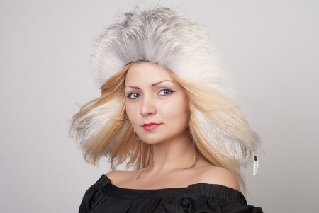Beautiful young woman in fur hat, portraitの写真素材