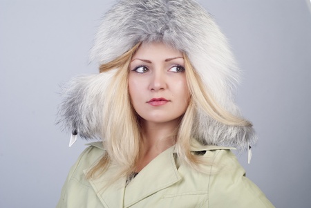 Beautiful young woman in fur hat, portraitの写真素材