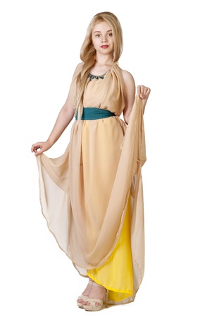 photo of beautiful young lady in original yellow dress over whiteの写真素材