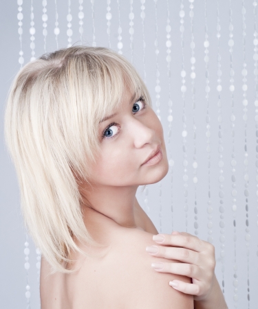 Beautiful young lady with blond hair and blue eyes, portraitの写真素材