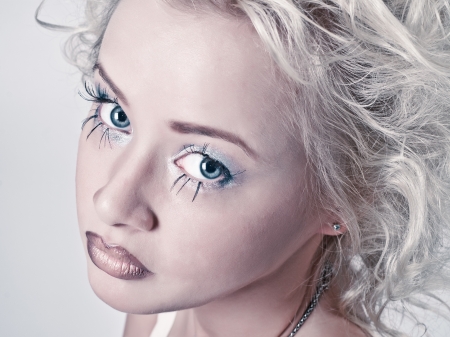 Attractive blond beauty portrait with original make up and hair dressの写真素材