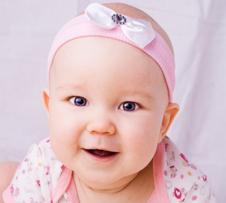 Baby with blue eyes smiling, 7 month newborn babyの写真素材