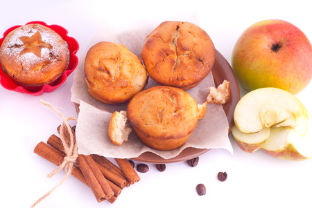 Muffin with apples and cinnamon sticks on the kitchenの写真素材