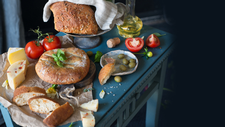 Food assortment - bread, cheese, tomato, italian style still life