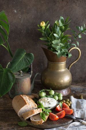 Food assortment - bread, cheese, tomato, italian style still lifeの写真素材