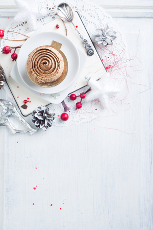 Cupcake with white brown cream over Christmas backgroundの写真素材