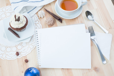 Chocolate cupcake with white cream over Christmas backgroundの写真素材