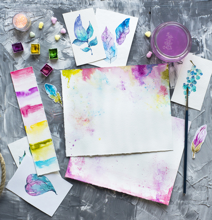 Watercolor drawings over gray modern stone background. Bright background for beautiful design, Top view, flat layの写真素材