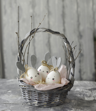 Easter decoration for home, handmade work, cute eggshell rabbit in a basket, beautiful  for card designの写真素材