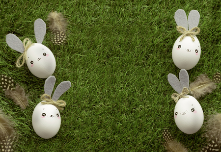 Easter decoration for home, handmade work, cute eggshell rabbits over green grass, beautiful  for card designの写真素材