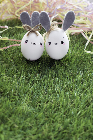Easter decoration for home, handmade work, cute eggshell rabbits over green grass, beautiful  for card designの写真素材