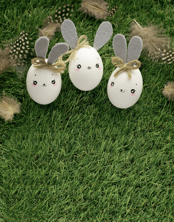 Easter decoration for home, handmade work, cute eggshell rabbits over green grass, beautiful  for card designの写真素材