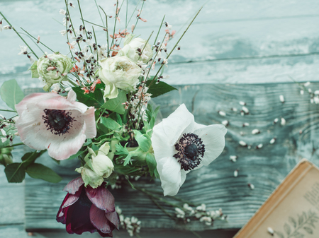 Flower bouquet with anemones, simple spring still life over wooden backgroundの写真素材