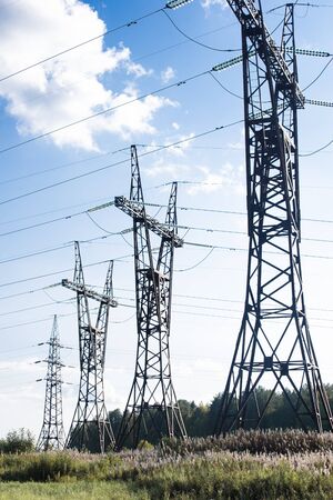 High voltage posts in scenic colourful autumn or late summer landscape, seasonal backgroundの写真素材