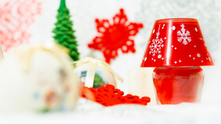 bright yellow decorative candle with christmas globesの写真素材