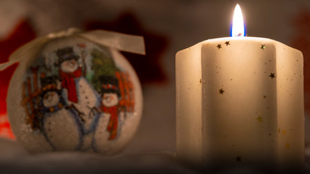bright yellow decorative candle with christmas globesの写真素材