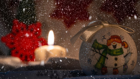 bright yellow decorative candle with christmas globesの写真素材