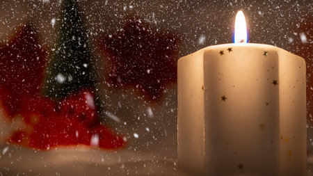 bright yellow decorative candle with christmas globesの写真素材