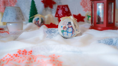 bright yellow decorative candle with christmas globesの写真素材