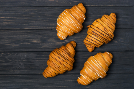 Fresh croissant on a black wooden background. Top view Copy spaceの写真素材