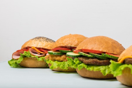 Craft beef burger on wooden table isolated on dark blue background.の写真素材
