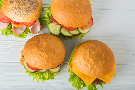 Craft beef burger on wooden table isolated on dark blue background.の写真素材