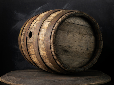 background of barrel and worn old table of woodの写真素材