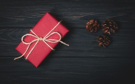 Gift red boxes over dark wooden background