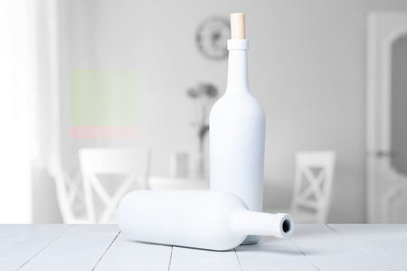 Red wine bottle on a white wooden backgroundの写真素材