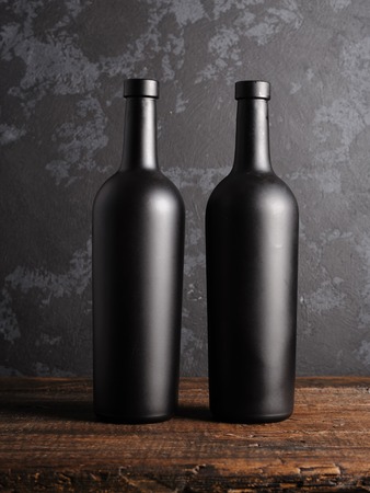 Red wine bottle on a wooden backgroundの写真素材