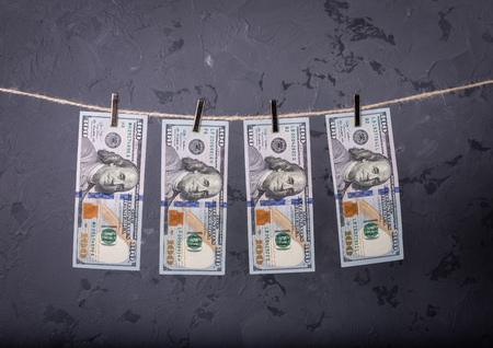 Money Laundering. Money Laundering US dollars hung out to dry. 100 dollar bills hanging on clotheslinesの写真素材