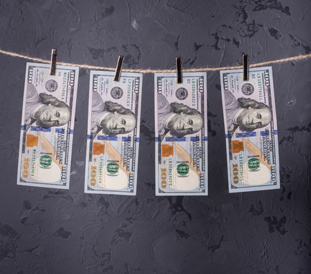 Money Laundering. Money Laundering US dollars hung out to dry. 100 dollar bills hanging on clotheslinesの写真素材